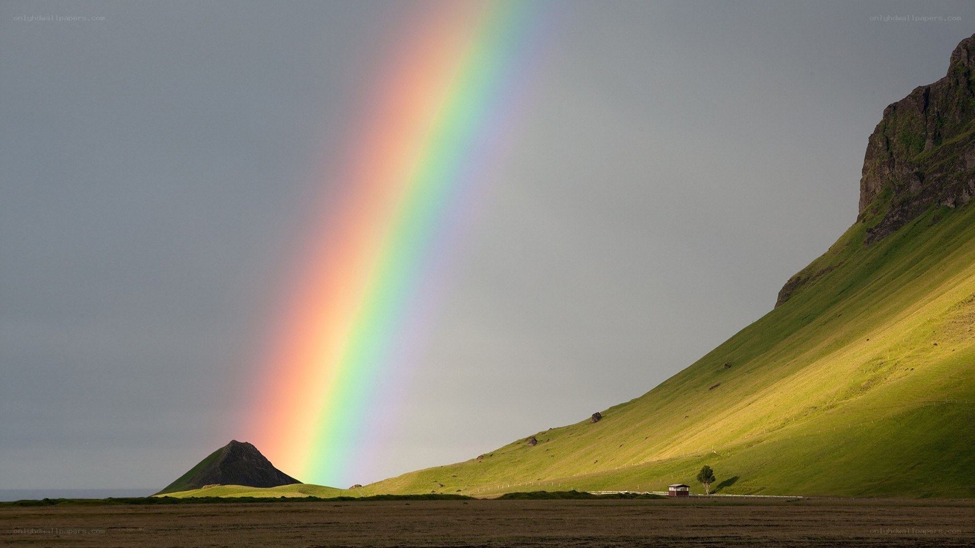 Rainbow over green hills