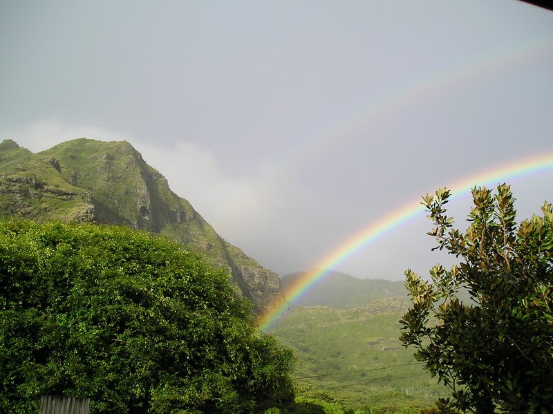 Rainbow over green mountains