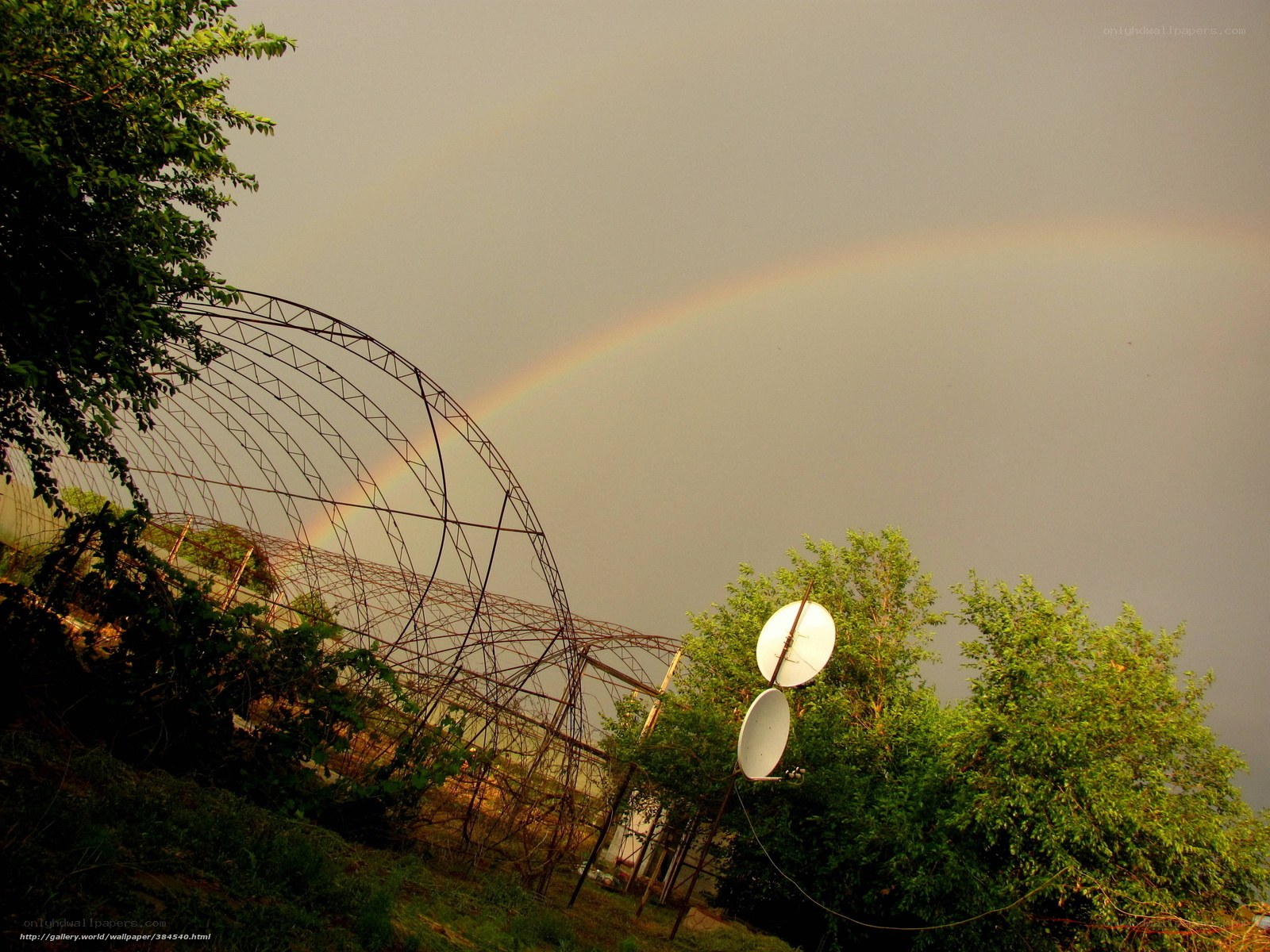 Rainbow over greenhouse structure
