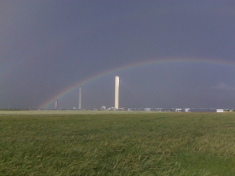 Rainbow over industrial towers