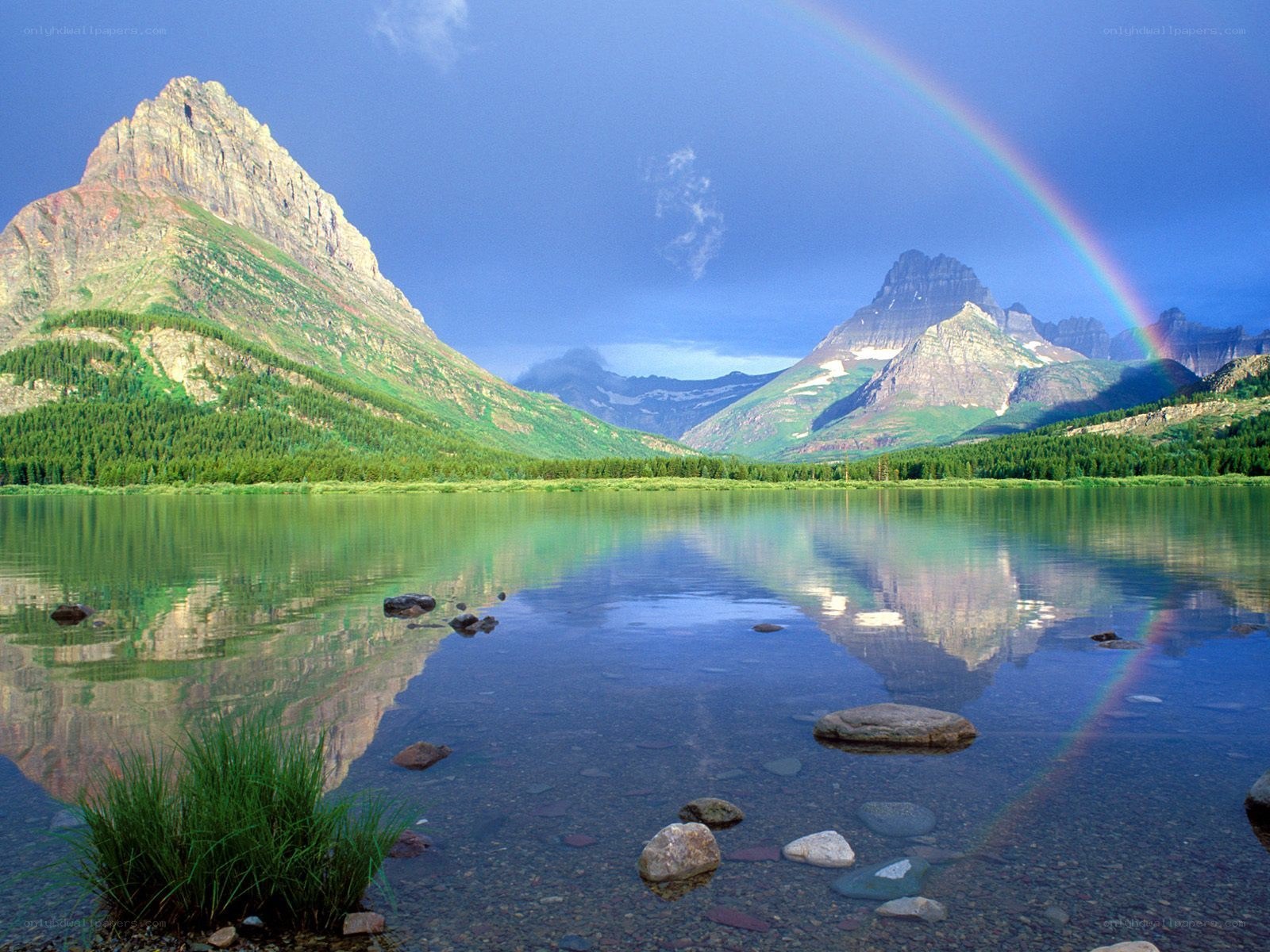 Rainbow over mountain lake