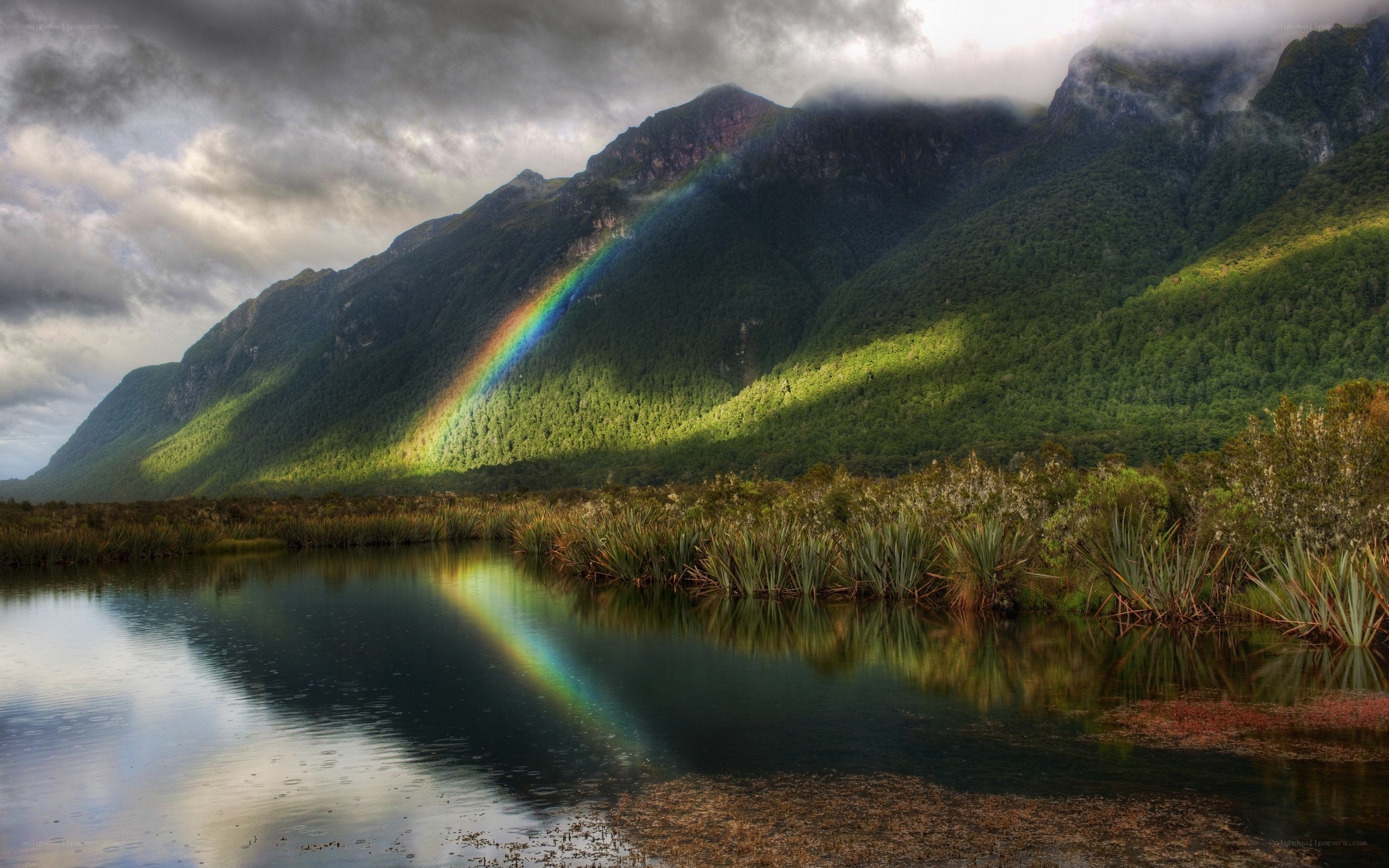 Rainbow over mountain lake
