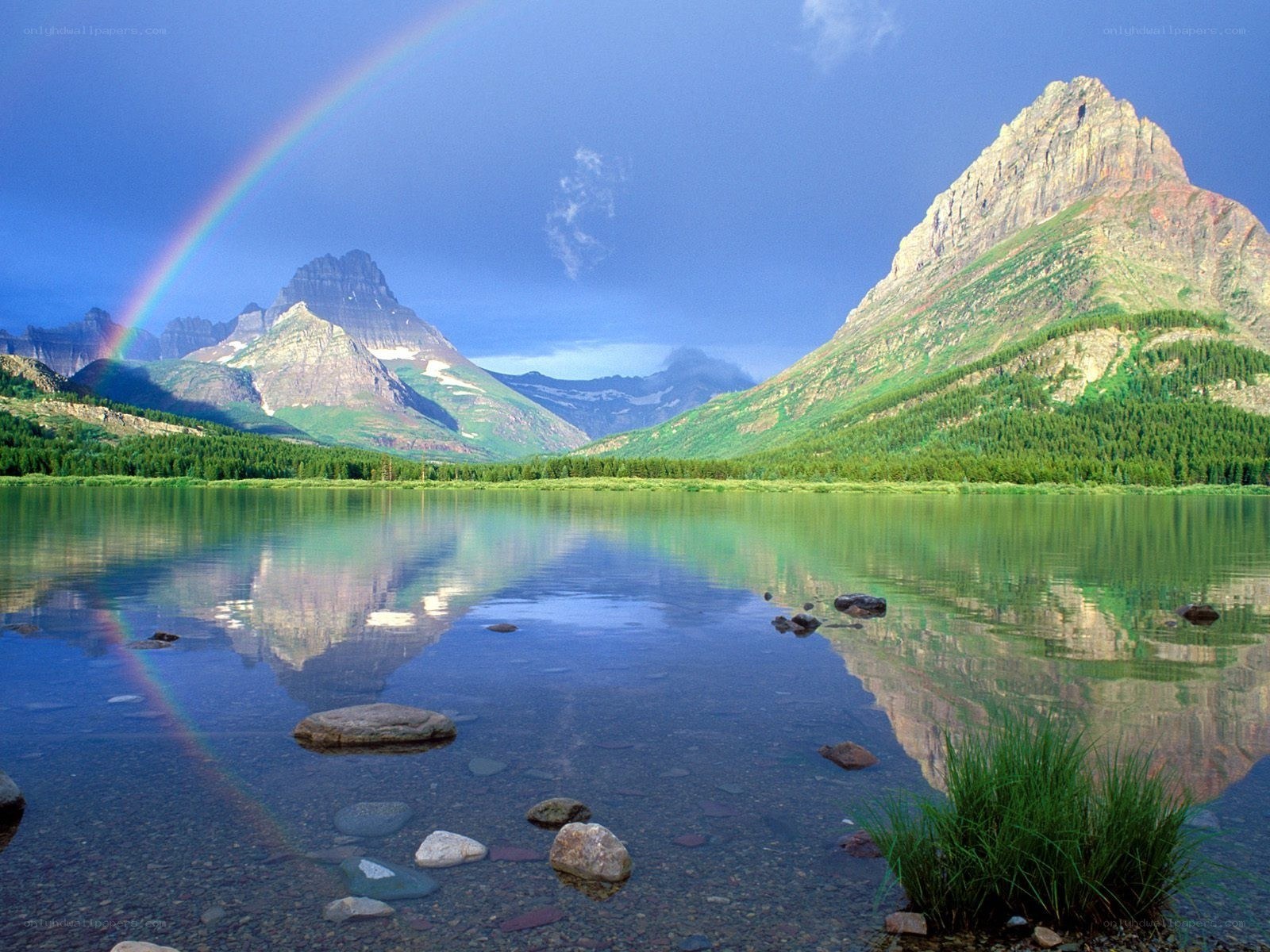 Rainbow over mountain lake