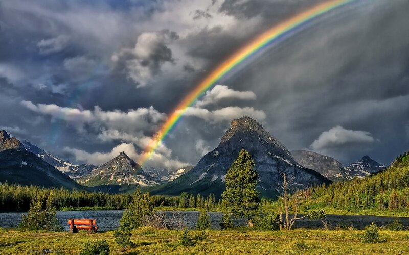 Rainbow over mountain lake