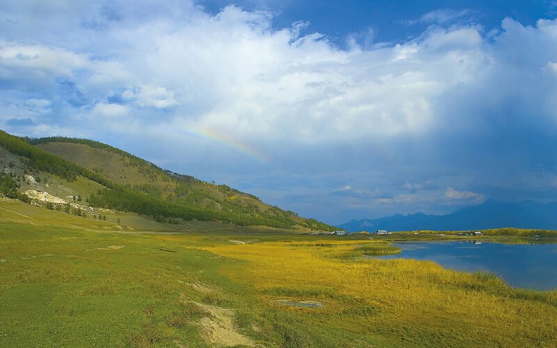 Rainbow over mountain lake