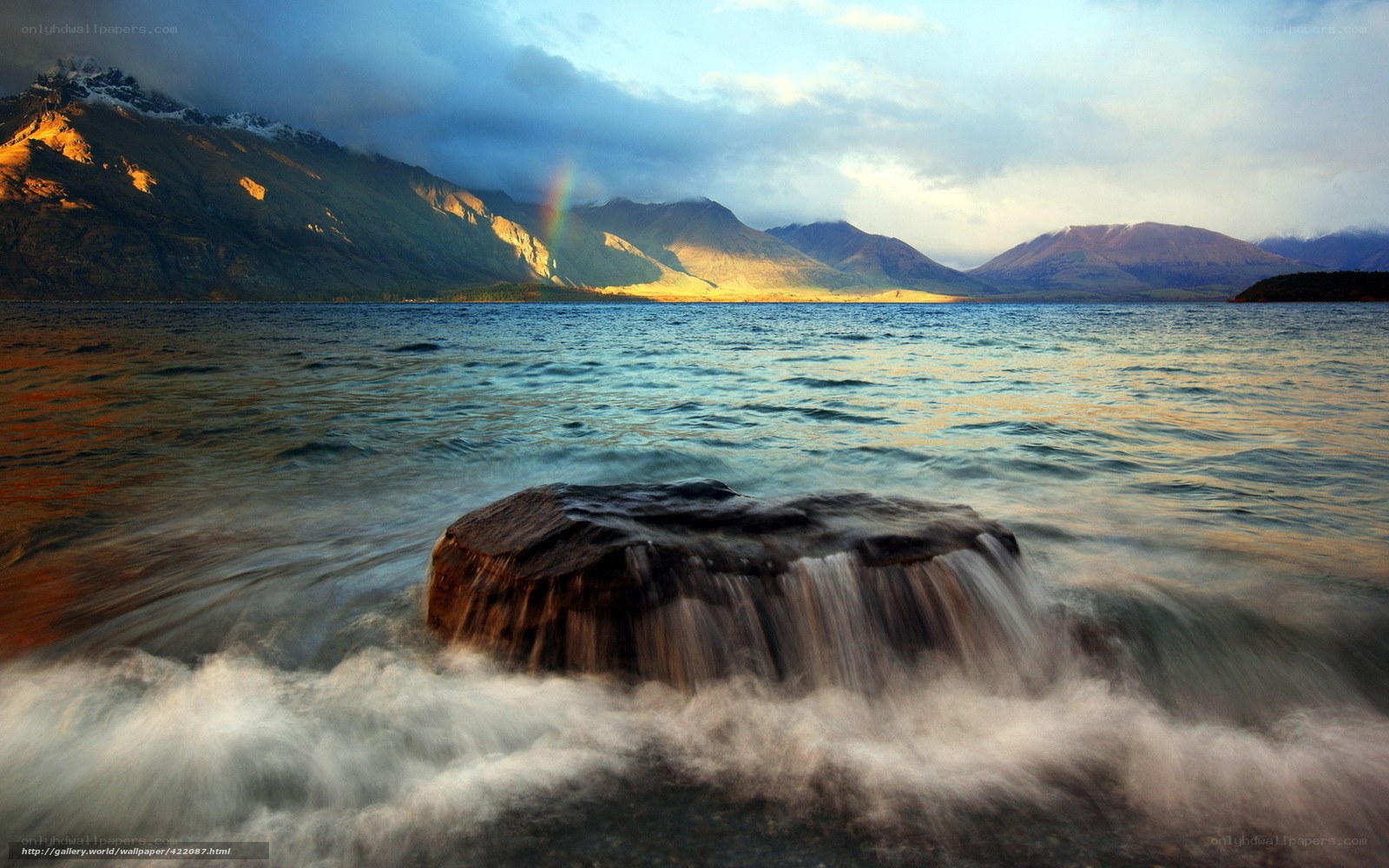 Rainbow over mountain lake