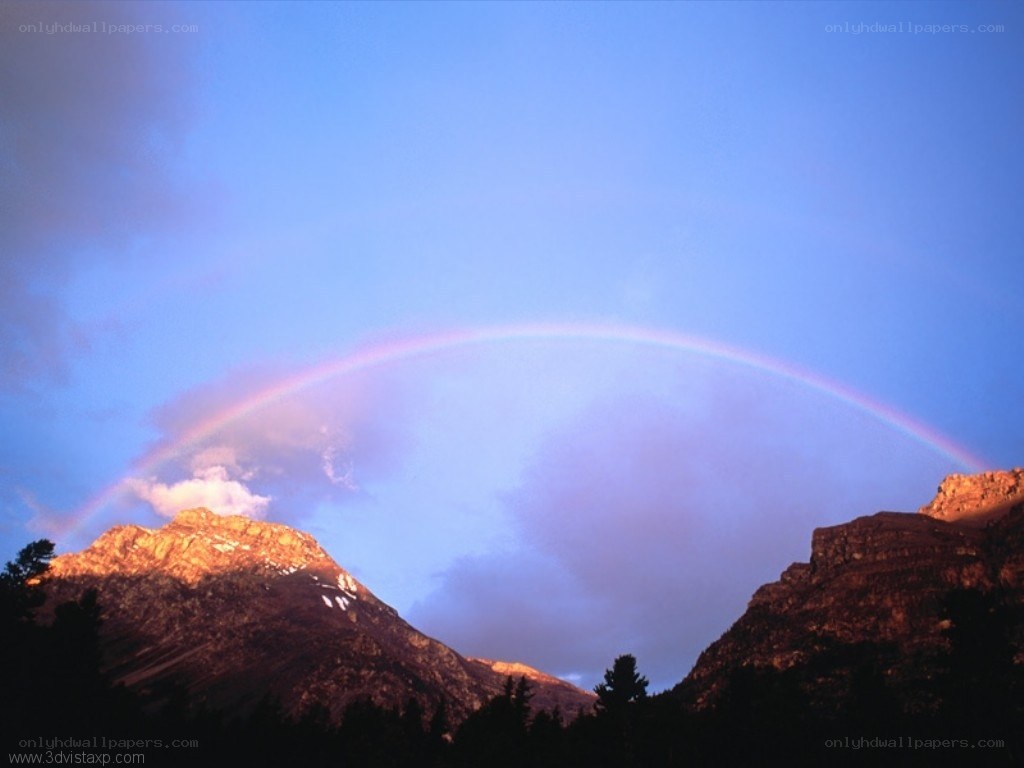 Rainbow over mountain peaks