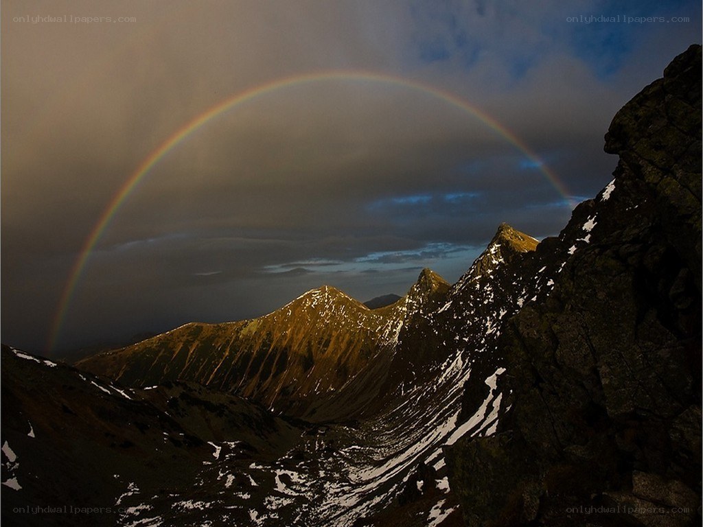 Rainbow over mountain peaks