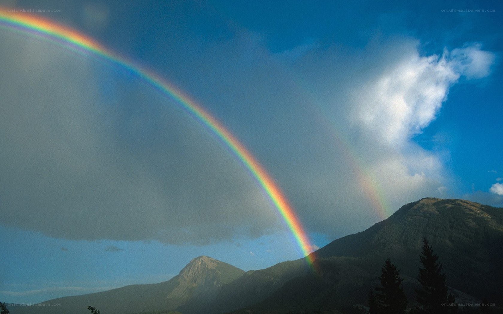 Rainbow over mountain peaks