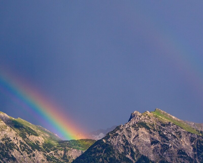 Rainbow over mountain peaks
