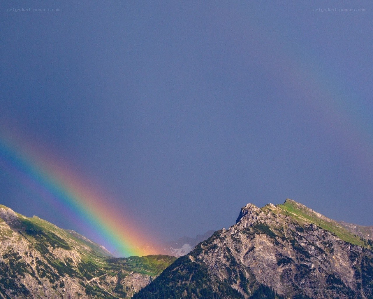 Rainbow over mountain peaks