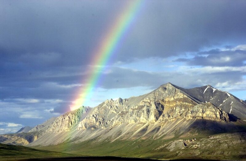 Rainbow over mountain range
