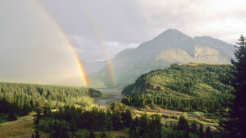 Rainbow over mountain valley