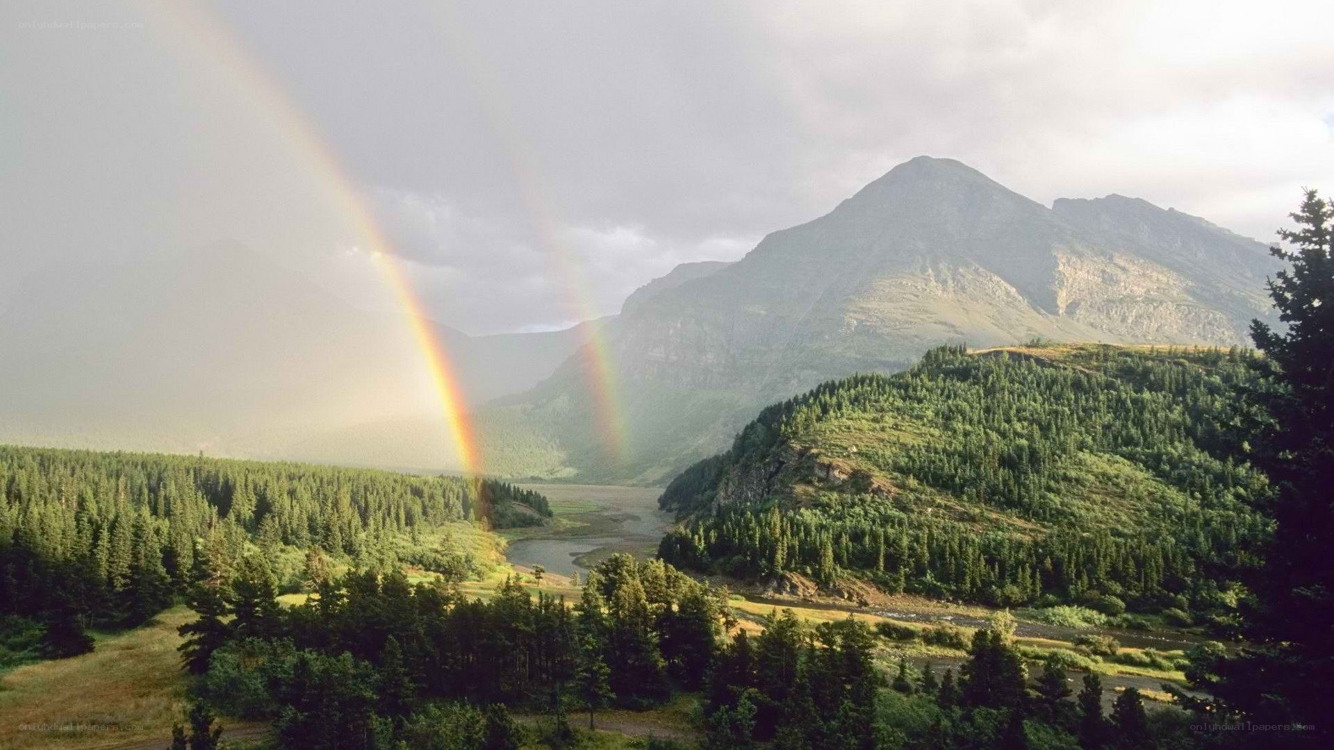 Rainbow over mountain valley