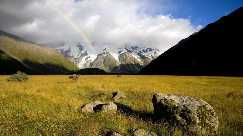 Rainbow over mountain valley