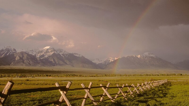 Rainbow over mountain valley