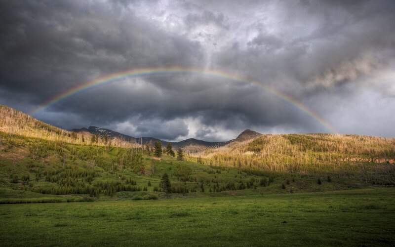 Rainbow over mountain valley