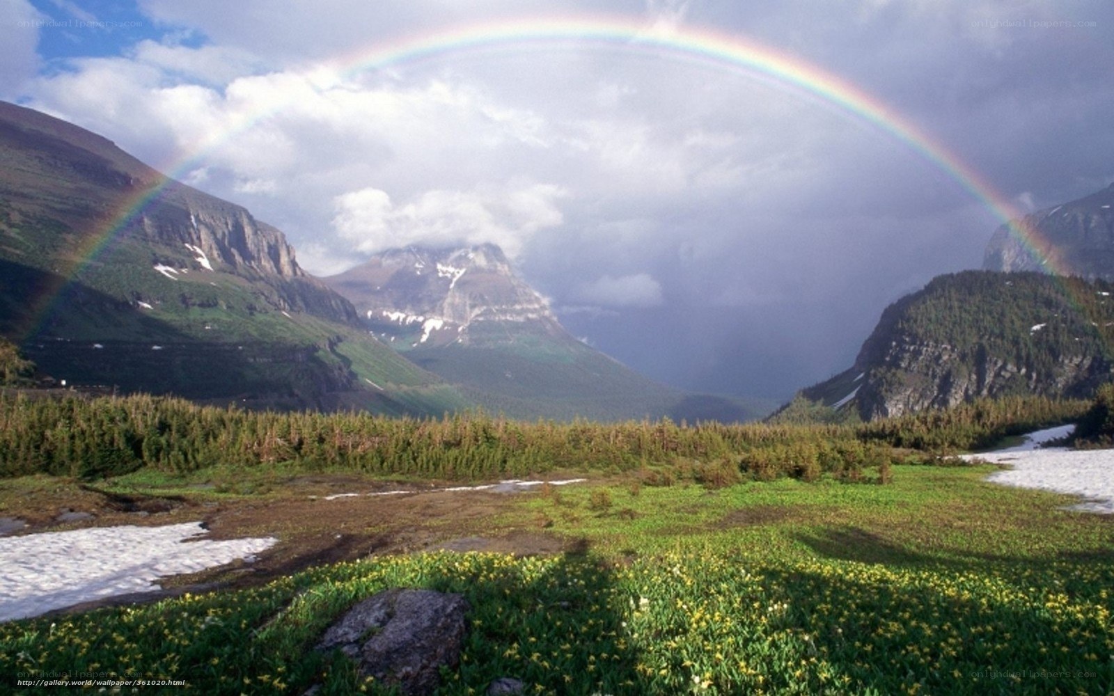 Rainbow over mountain valley