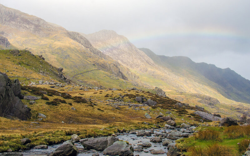 Rainbow over mountain valley