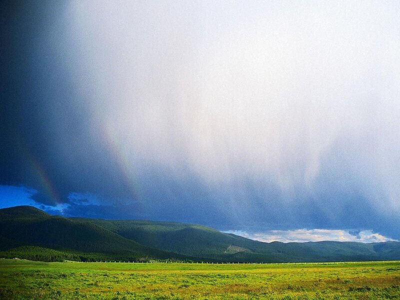 Rainbow over mountain valley