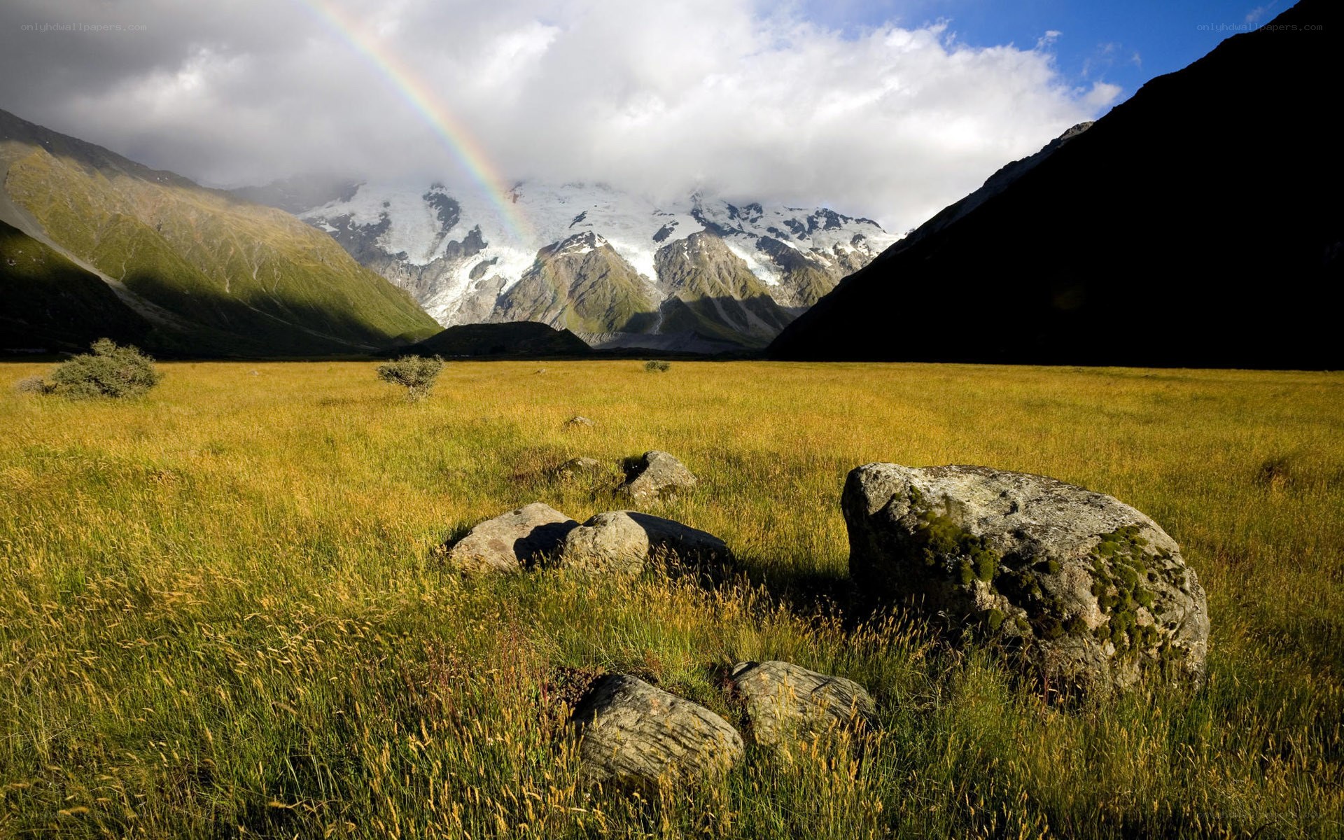 Rainbow over mountain valley
