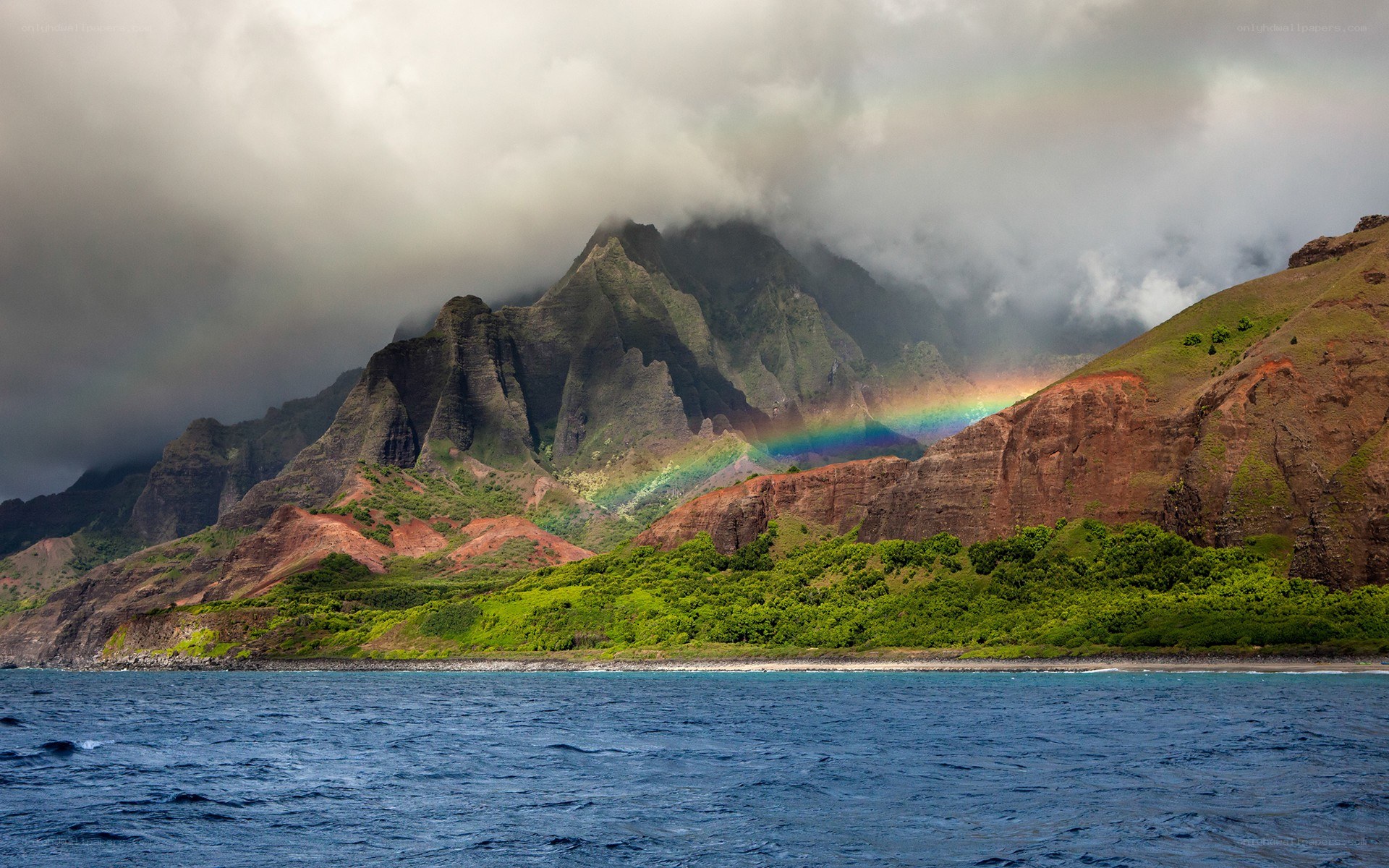 Rainbow over mountainous coast