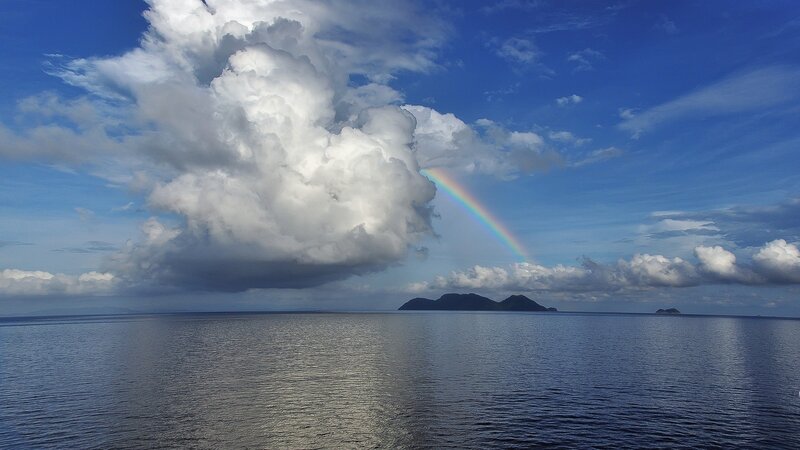 Rainbow over Ocean — Blue, Serene, Afternoon, Photograph, Clouds, Island, Sky, White