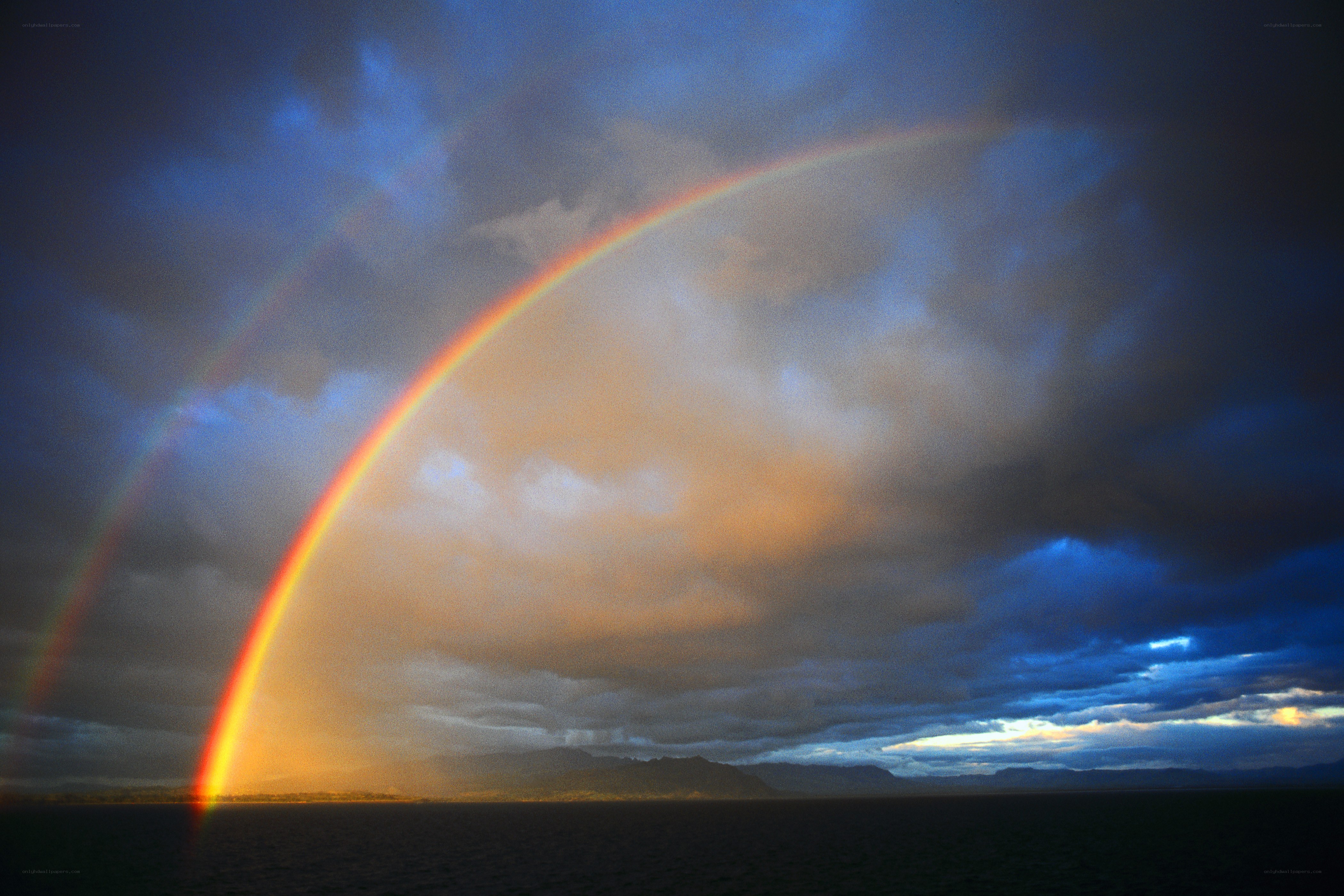 Rainbow over ocean landscape