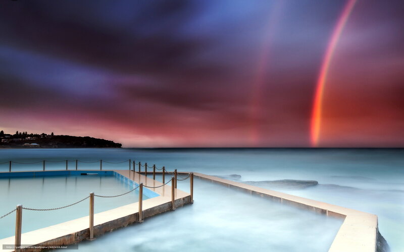 Rainbow over ocean pool