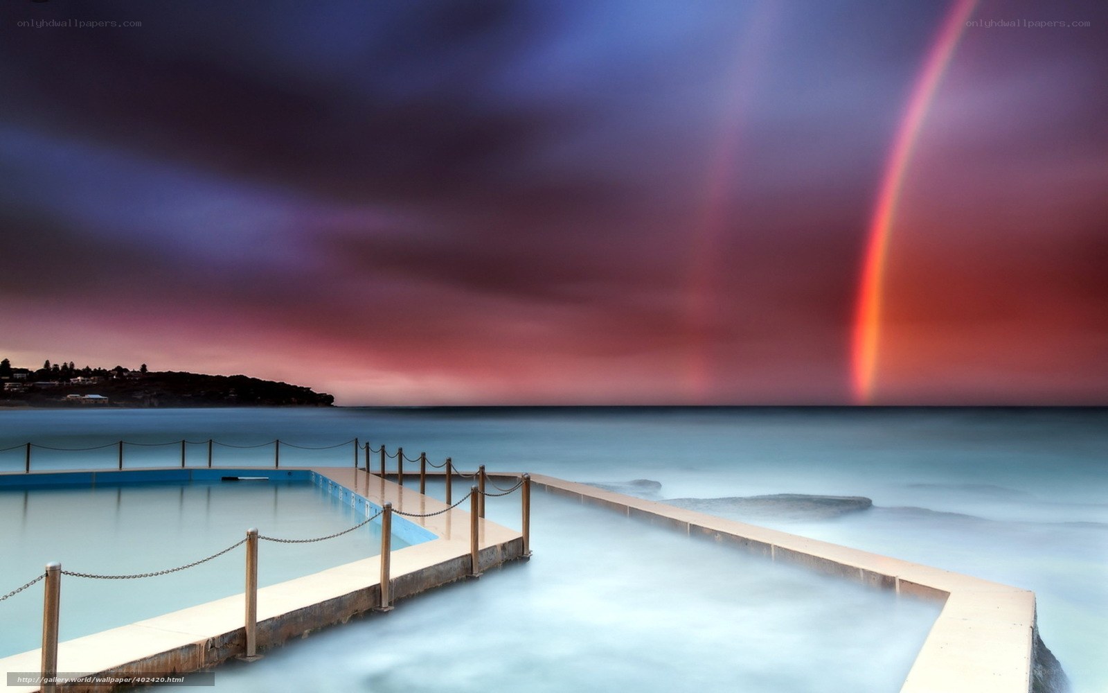 Rainbow over ocean pool