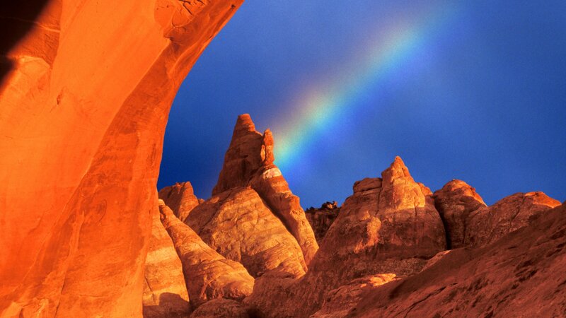 Rainbow over red rock arch