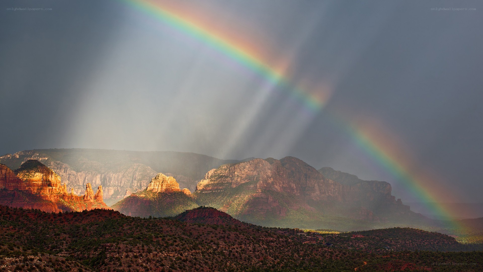 Rainbow over red rock canyon