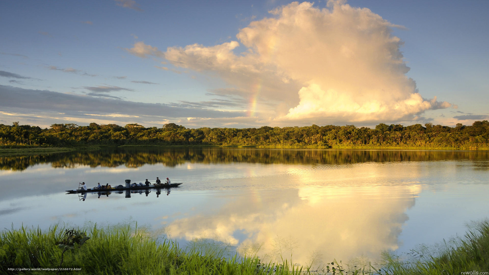 Rainbow over river at sunset