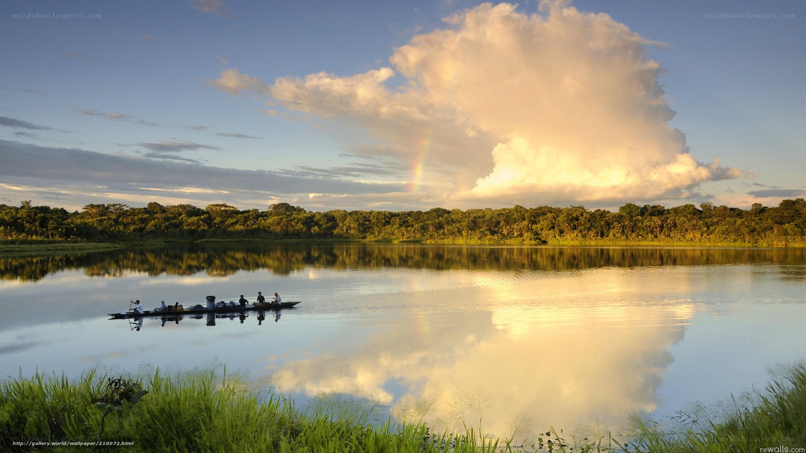 Rainbow over river at sunset