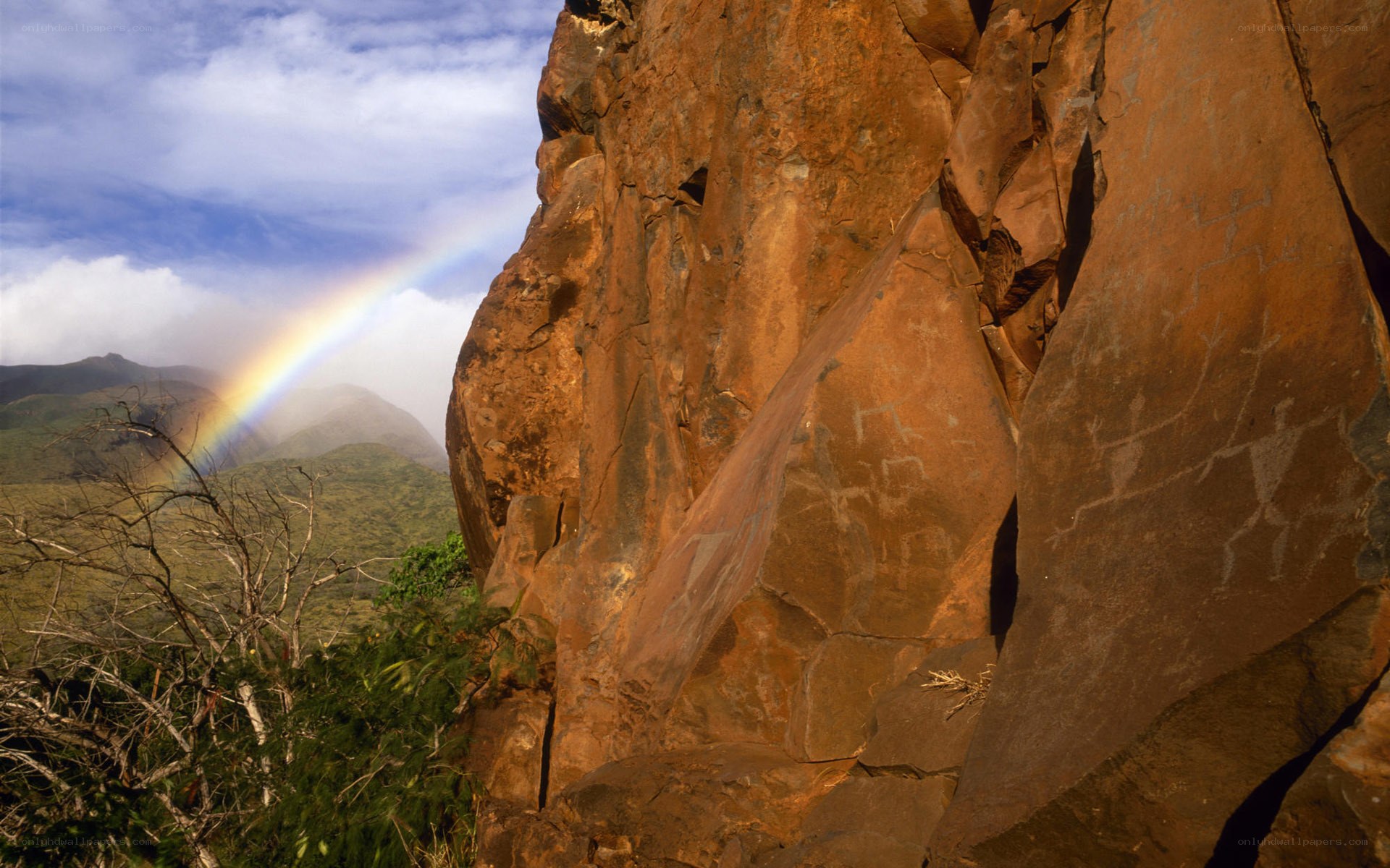 Rainbow over rock carvings