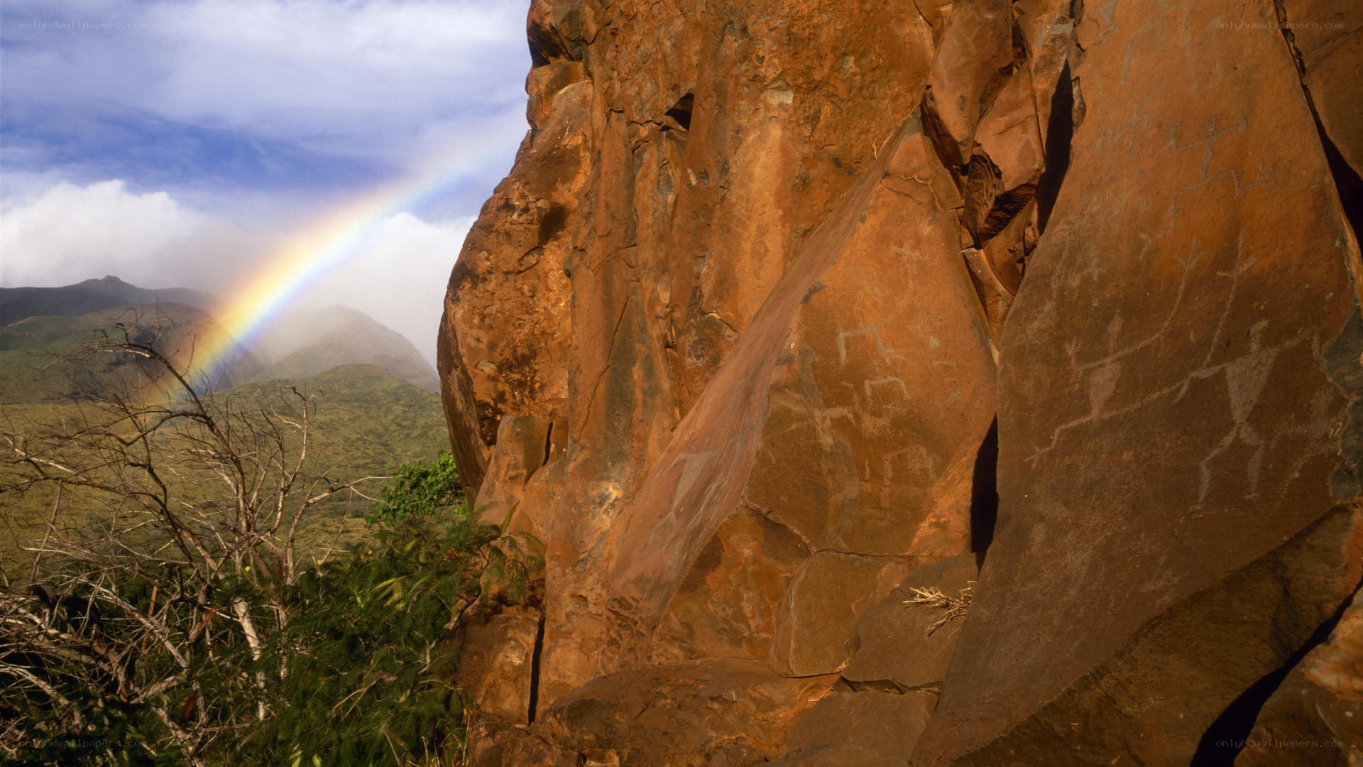 Rainbow over rock carvings
