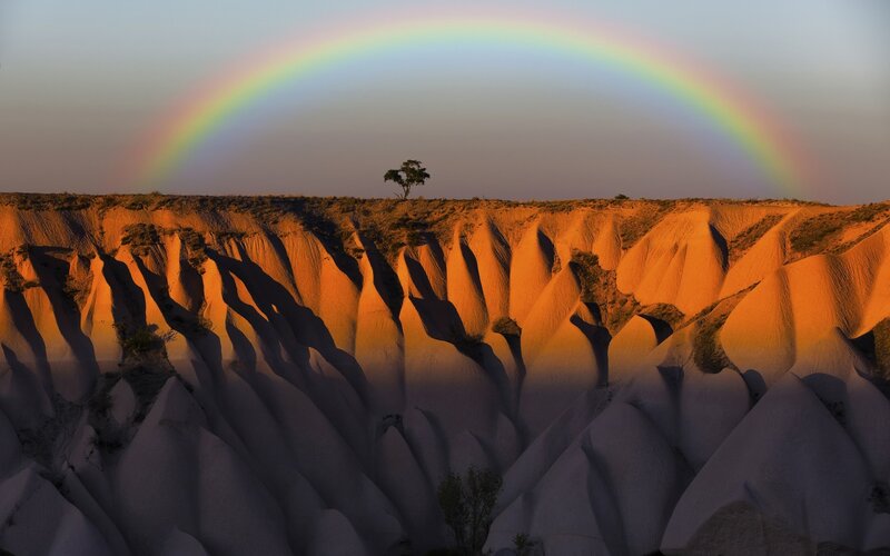 Rainbow over Rock Formations — Orange, Serene, Sunset