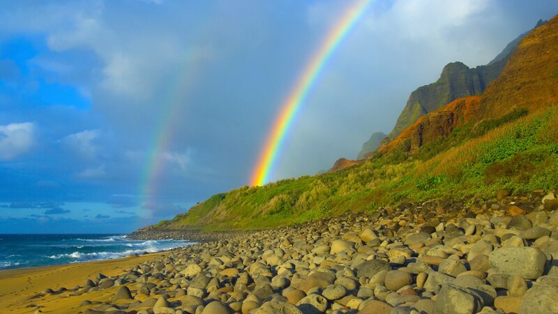 Rainbow over rocky beach