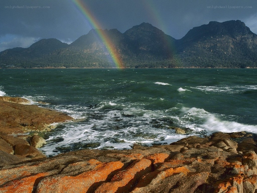Rainbow over rocky coast
