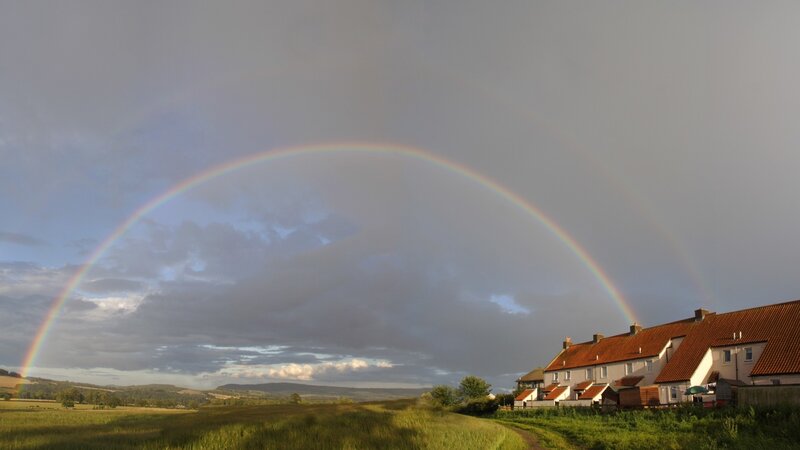 Rainbow over rural village