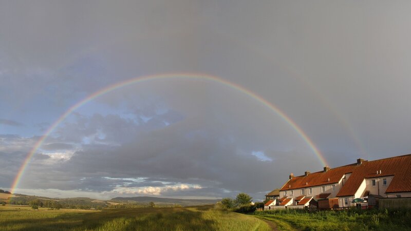 Rainbow over rural village