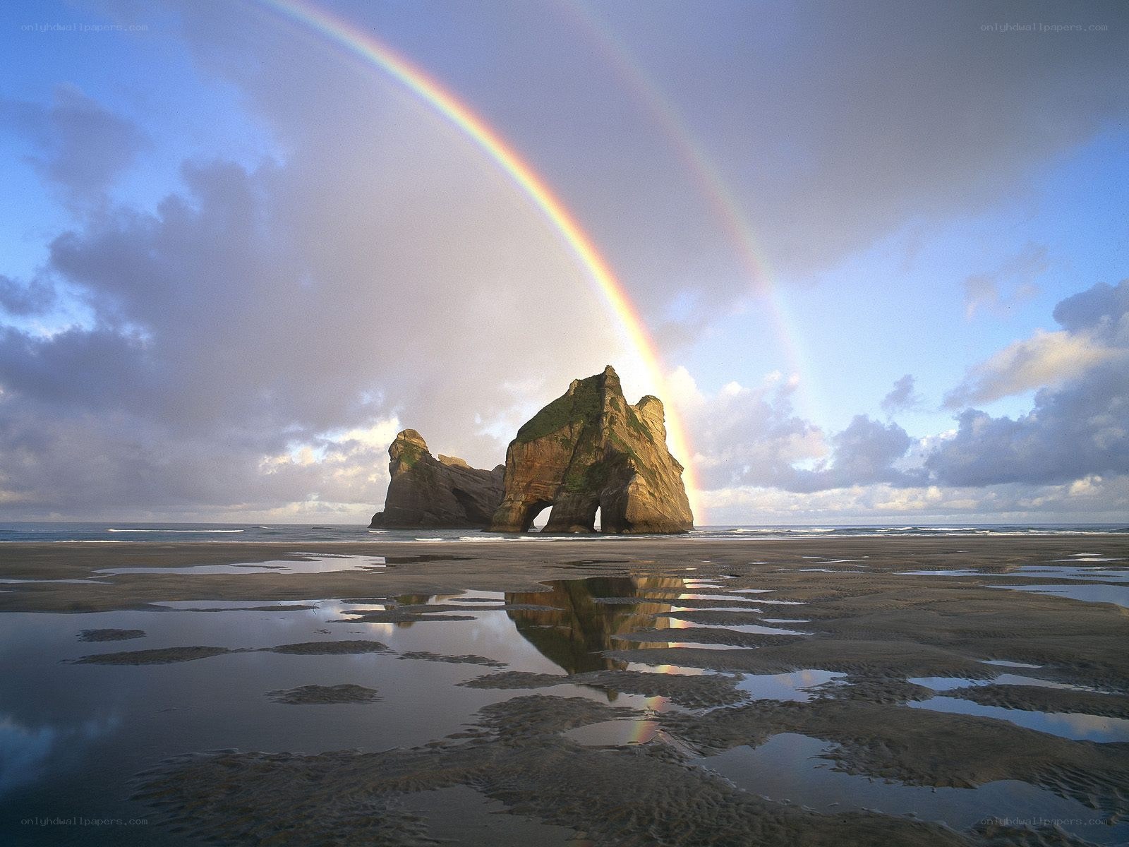 Rainbow over sea arch