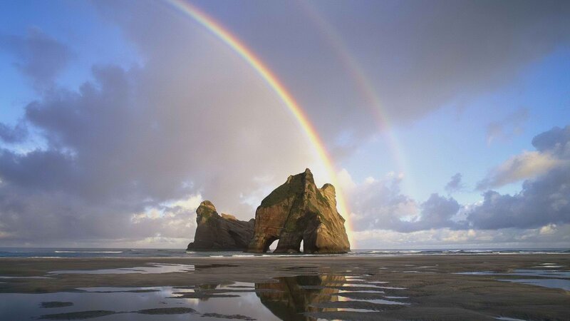 Rainbow over sea arch