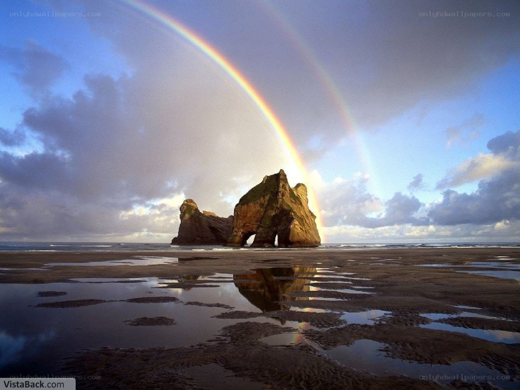 Rainbow over sea arch