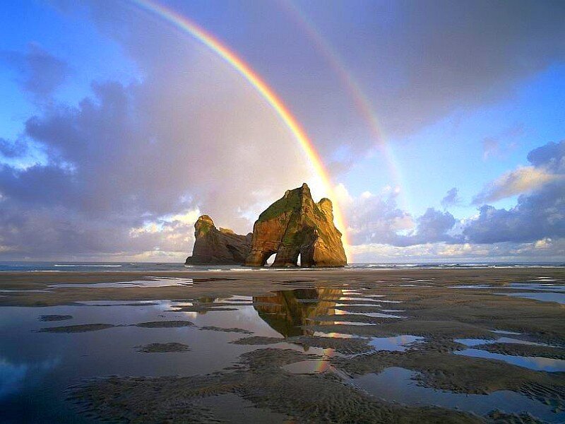 Rainbow over sea arch