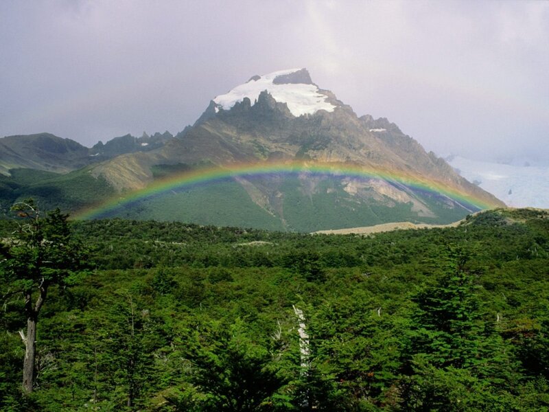 Rainbow over snow-capped mountain