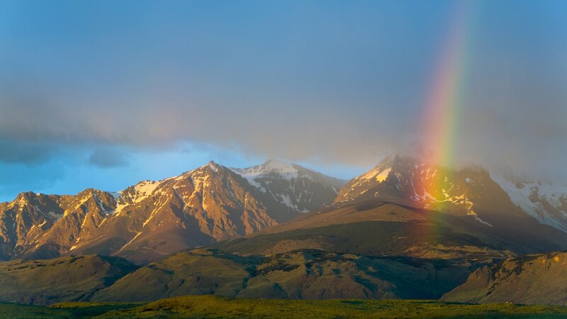 Rainbow over snow-capped mountains