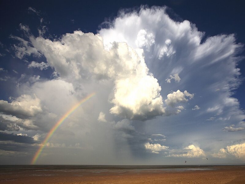Rainbow over stormy beach
