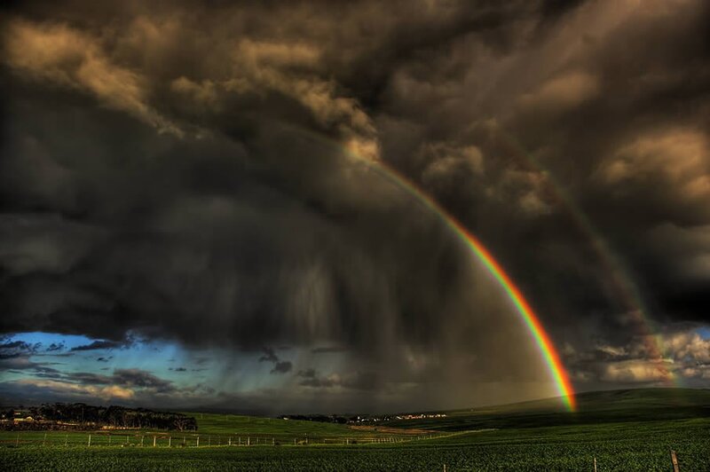 Rainbow over stormy fields