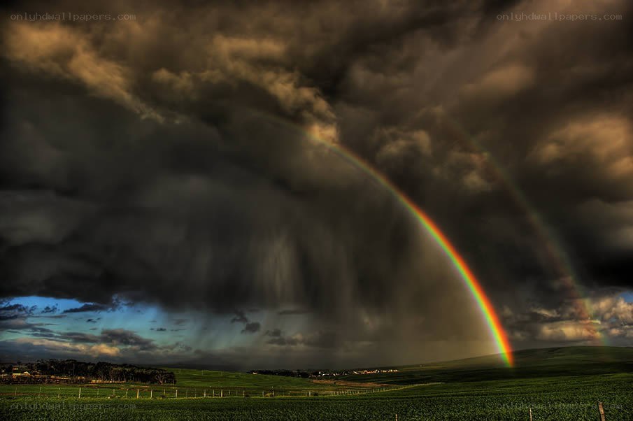 Rainbow over stormy fields
